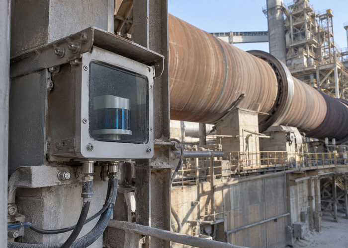 real cement plant rotary kiln area with workers at safe distance and visible unbranded physical industrial LiDAR monitoring equipment validation scene 2