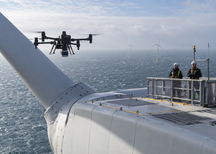 real offshore wind turbine nacelle with an unbranded inspection drone carrying physical LiDAR approaching a marked maintenance landing area in a realistic LiDAR application scene