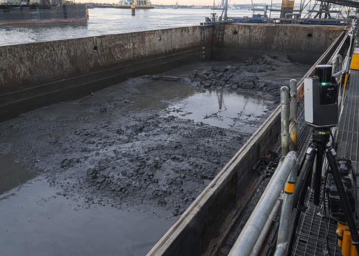 real dredging work barge with uneven wet sediment load scanned by a physical unbranded LiDAR from a safe dockside mount validation scene 2