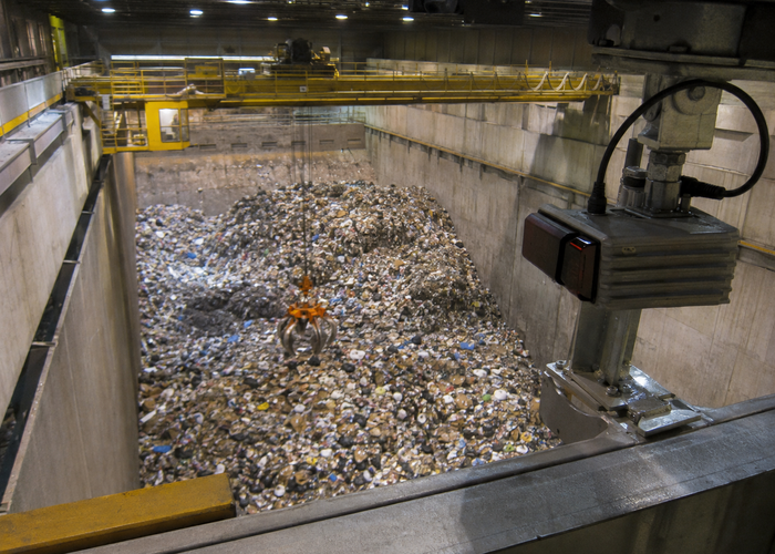 overhead LiDAR scanner measuring an active waste-transfer bunker with a crane in a realistic LiDAR application scene