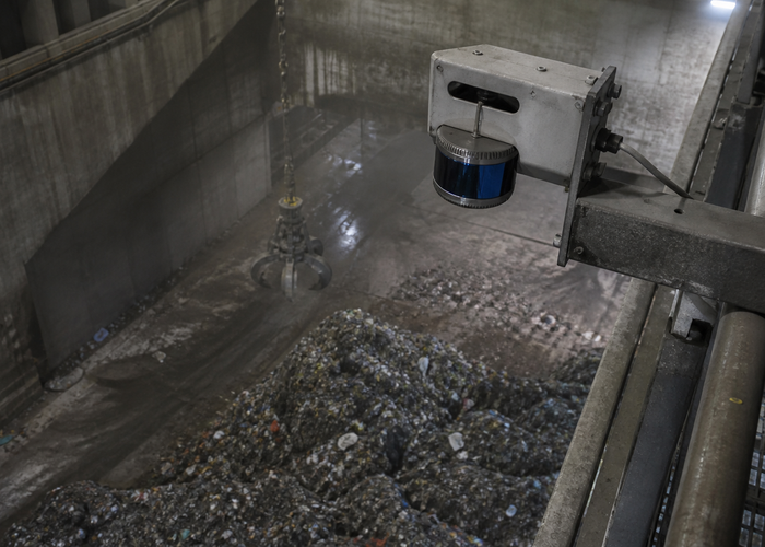 overhead LiDAR scanner measuring an active waste-transfer bunker with a crane validation scene 2
