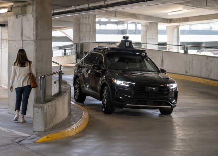 real parking garage with an unbranded passenger vehicle carrying visible physical LiDAR sensors during automated valet parking validation validation scene 3