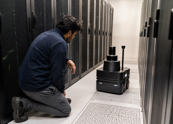 autonomous inspection robot with physical LiDAR navigating a realistic data center aisle validation scene 3
