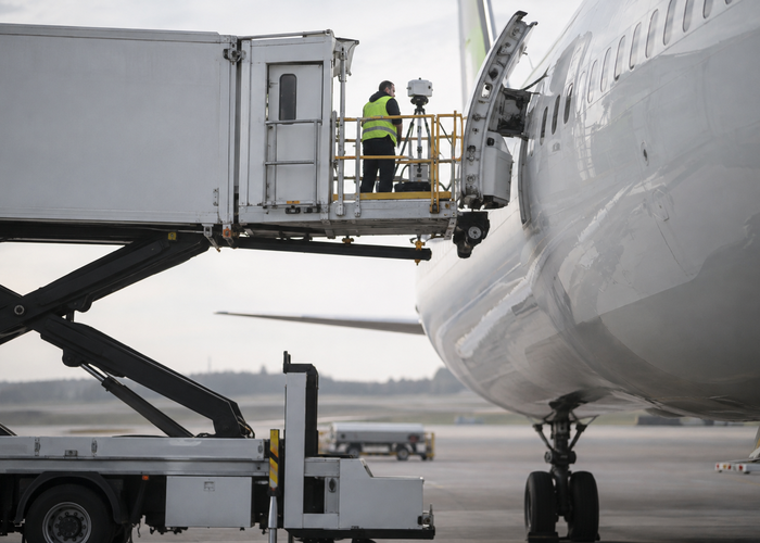 real unbranded airport catering high-lift truck with visible physical LiDAR approaching an aircraft galley door under crew supervision validation scene 2