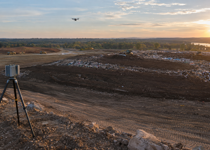 real landfill working face after daily cover placement with a drone LiDAR survey and tripod scanner while dozers are parked outside the capture area in a realistic LiDAR application scene