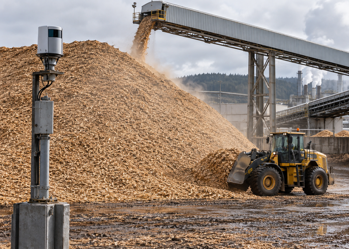 real pulp mill wood chip stockyard with a conveyor, wheel loader and an unbranded physical LiDAR scanner mapping a large irregular pile in a realistic LiDAR application scene